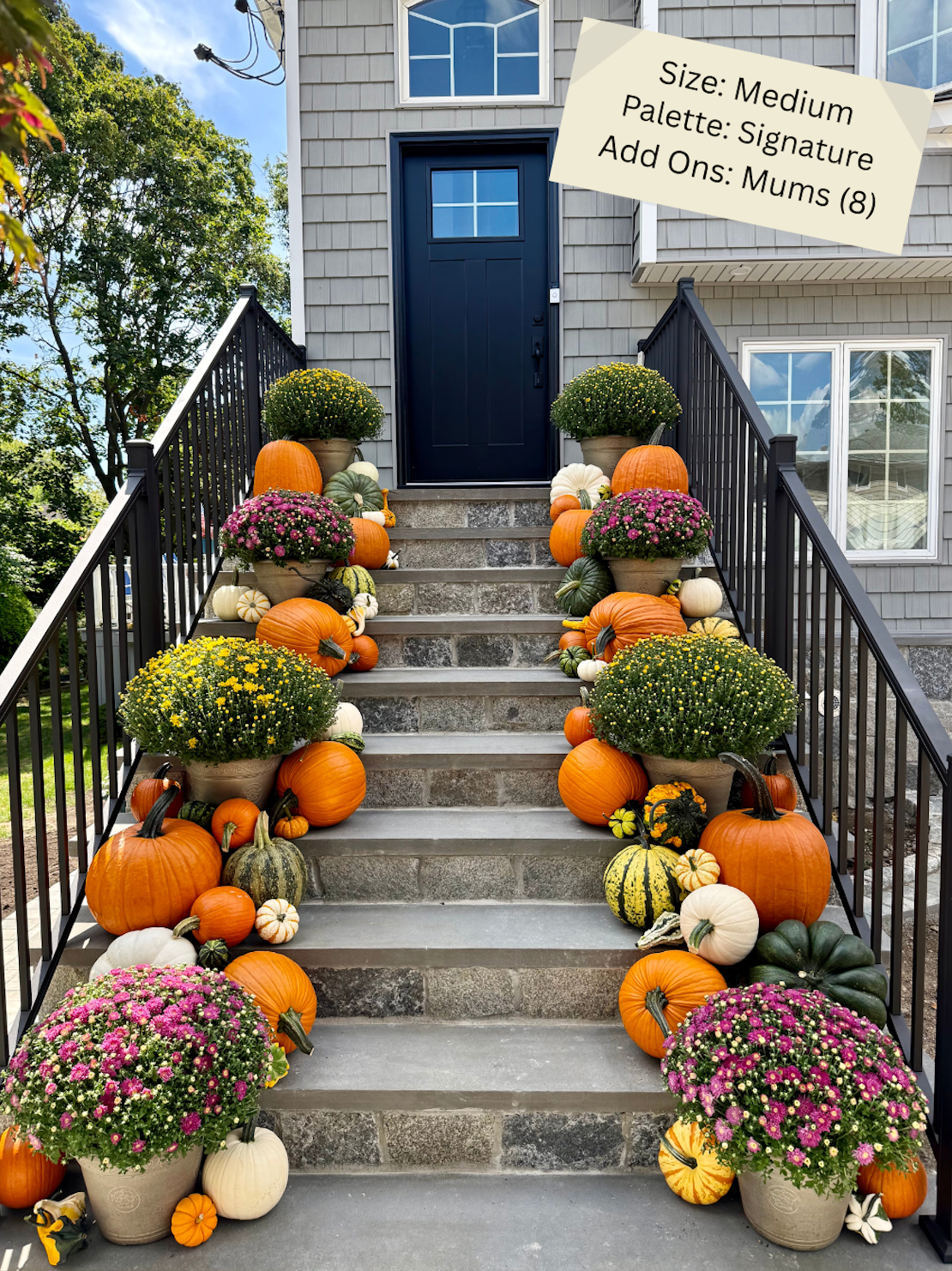 Staircase decorated with pumpkins and mums in front of a home entrance