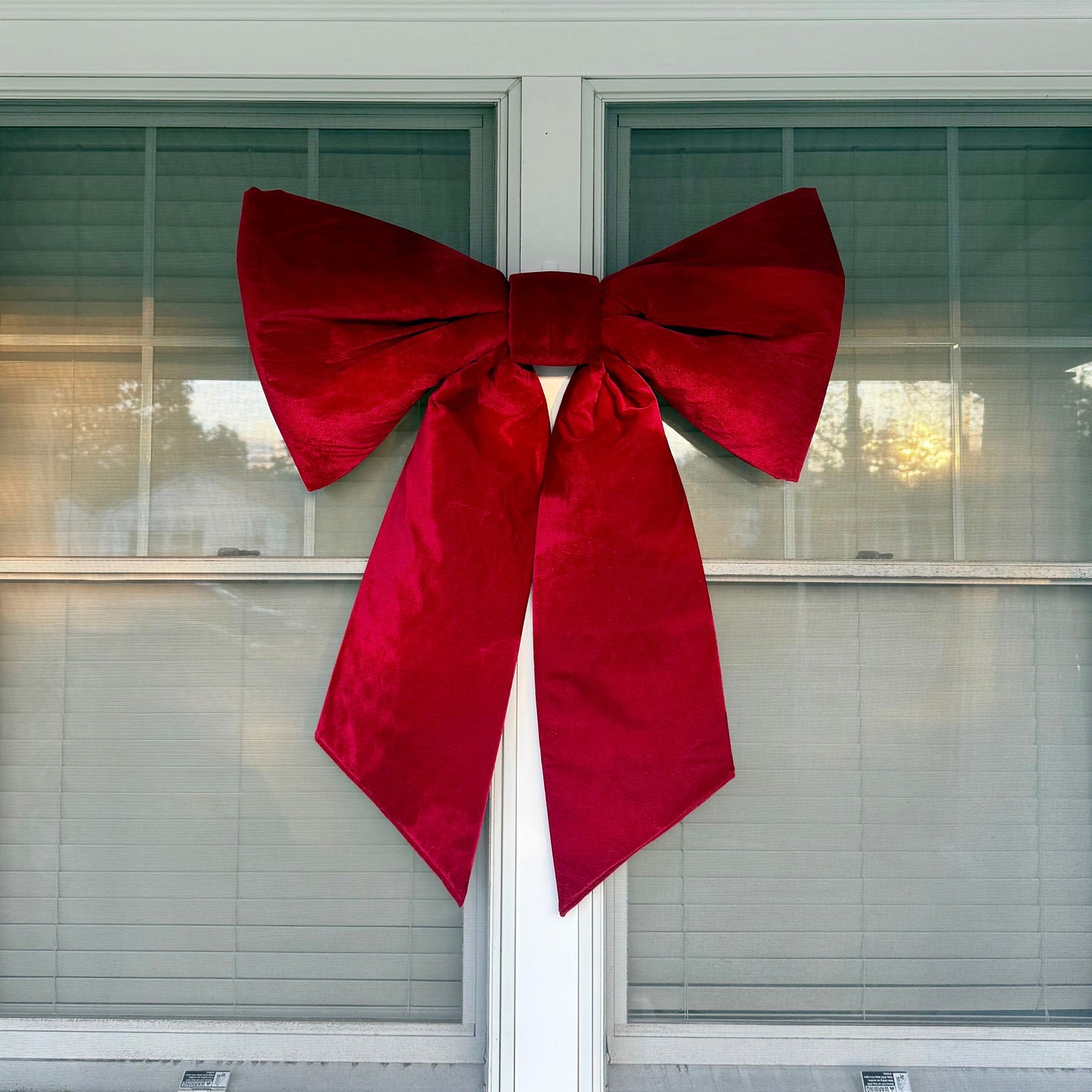 Red bow decoration on a window of a house